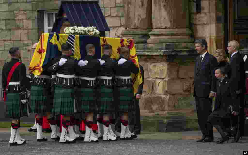 From 2nd right, Vice Admiral Timothy Laurence, Princess Anne, Prince Andrew and Sophie, Countess of Wessex watch as the coffin of Queen Elizabeth II completes its journey from Balmoral to the Palace of Holyroodhouse, where it will lie in rest for a day, in Edinburgh, Sept. 11, 2022. 