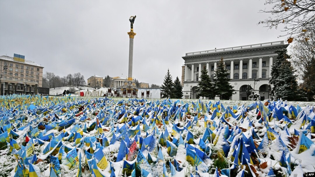 This Nov. 17, 2022, photo shows Ukrainian flags set at Independence Square in Kyiv, symbolizing the deaths of Ukrainian soldiers in the conflict, covered with snow after the first snow falls of the season.