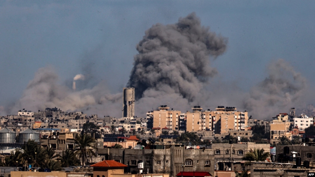 This picture taken from Rafah, in the southern Gaza Strip, shows smoke rising over buildings in Khan Yunis during Israeli bombardment on Feb. 1, 2024.