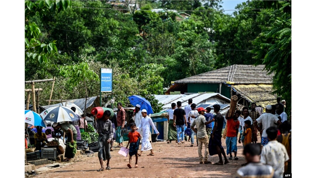 Rohingya refugees gather to buy essentials at a market area in Kutupalong camp a day after cyclone Mocha made landfall, in Ukhia, Bangladesh, May 15, 2023.