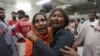 Women at a morgue in Karachi, Pakistan, mourn the loss of a family member who was killed in a stampede at a Ramadan food distribution center, March 31, 2023. 