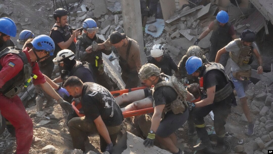 Rescuers carry a wounded man after a Russian missile attack on a sports complex in Kharkiv, Ukraine, Sept. 1, 2024.