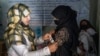 FILE - An Afghan woman is checked by a nutritionist at a clinic run by the World Food Program, in Kabul, Afghanistan, Jan. 26, 2023. The Taliban has restricted the rights of Afghan women, including prohibiting Afghan women from working for the United Nations in Afghanistan.