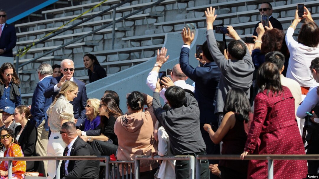 President Joe Biden waves as members of the crowd snap photos of him and his family as they attend the University of Pennsylvania graduation ceremony where granddaughter Maisy Biden received her degree in Philadelphia, May 15, 2023.