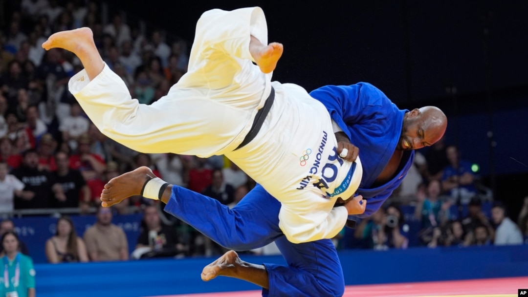 South Korea's Min-Jong Kim and France's Teddy Riner compete during their men's +100 kg final match in the team judo competition, at Champ-de-Mars Arena, during the 2024 Summer Olympics, in Paris, France, Aug. 2, 2024.