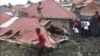 FILE - In this photo taken from video, people gather at a site of a collapsed landfill in Kampala, Uganda, Aug. 10, 2024. 