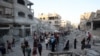 Palestinians gather to check a building shortly after it was leveled by Israeli bombing in the Nuseirat refugee camp in the central Gaza Strip, Aug. 22, 2024.