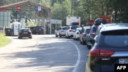 Cars line up at border crossing Sumskas between Lithuania and Belarus, Aug. 12, 2023. Next week, Lithuania will shut two of its six existing border checkpoints with Belarus, including the crossing in Sumskas. 