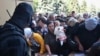 Evacuated people in the Kursk region queue to fill out forms for humanitarian aid at an aid distribution center in Kursk, Russia, Aug. 14, 2024. 