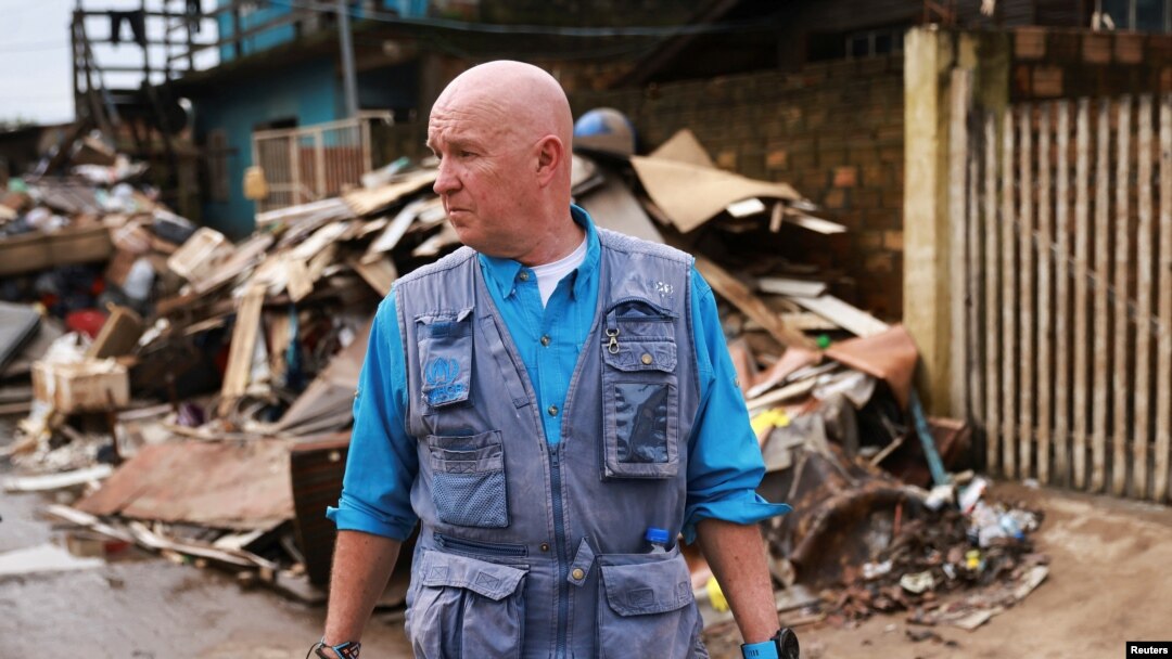 Andrew Harper, climate advisor for the UN refugee agency known as UNHCR, visits a neighborhood partially destroyed by the floods that hit Porto Alegre, in the state of Rio Grande do Sul, Brazil, June 23, 2024.