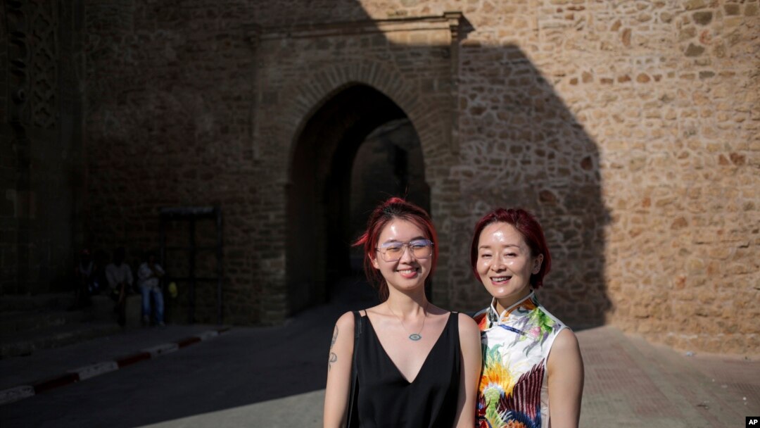 FILE - Chinese tourists pose for a photo outside a tourist attraction in Rabat, Morocco, on Aug. 17, 2018. African nations are pushing to attract visitors from China after the travel restrictions of the COVID-19 pandemic.