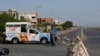 A guard stands on a barricaded road that leads to the beach, after a ban was imposed on coastal activities following the cyclonic storm, Biparjoy, over the Arabian Sea, at Clifton Beach in Karachi, Pakistan, June 12, 2023. 