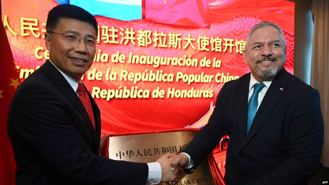Honduran Foreign Minister Eduardo Enrique Reina, right, and Chinese envoy Yu Bo shake hands during the inauguration of the Chinese embassy in Tegucigalpa on June 5, 2023.