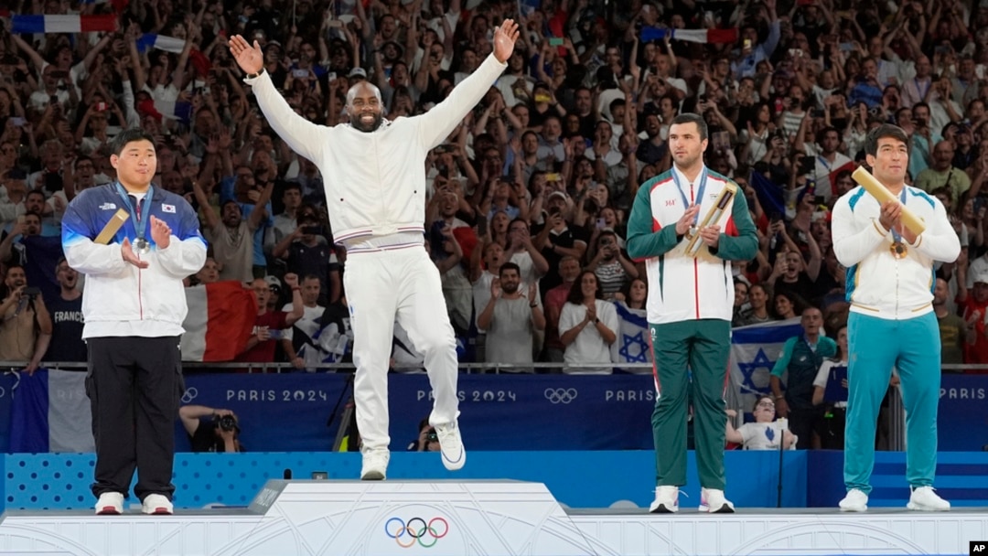 France's Teddy Riner celebrates his gold medal on the podium of the judo men's +100 kg event in the team judo competition, at Champ-de-Mars Arena, during the 2024 Summer Olympics, in Paris, France.