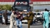FILE - Plainclothes police officers beat a supporter of Pakistan's former Prime Minister Imran Khan during a protest to condemn the arrest of their leader in Peshawar, May 9, 2023. 