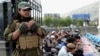 A Taliban fighter and Afghan people pray during Eid al-Adha, in Kabul, Afghanistan, June 28, 2023. The Taliban ordered, July 11, 2023, the suspension of all Swedish activities in Afghanistan because of the public burning of the Quran at a protest in Sweden last month.