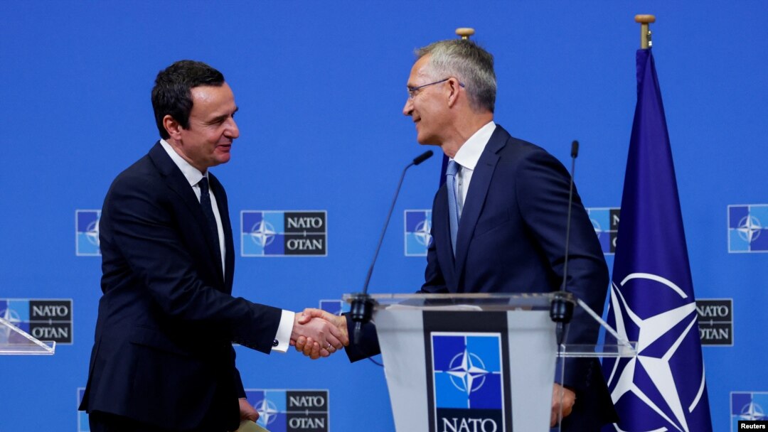 NATO Secretary-General Jens Stoltenberg shakes with Kosovo's Prime Minister Albin Kurti in Brussels, Aug. 17, 2022.
