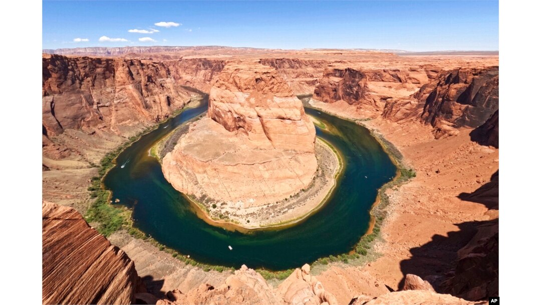 FILE - The Colorado River flows at Horseshoe Bend in the Glen Canyon National Recreation Area, in Page, Arizona, June 8, 2022.
