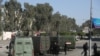 Egyptian riot policemen surround the entrance of al-Azhar university during clashes with students who support the Muslim Brotherhood, in Cairo's eastern Nasr City district on December 27, 2013. 