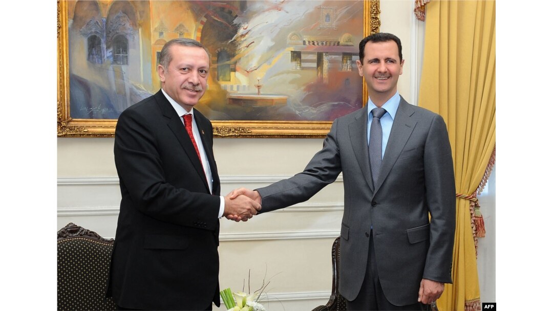 FILE - Syrian President Bashar al-Assad, right, shakes hands with Turkish Prime Minister Recep Tayyip Erdogan during a meeting in Aleppo, Feb. 6, 2011. (Photo by SANA / AFP)