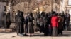 FILE - Afghan female university students are stopped by Taliban security personnel next to a university in Kabul, Dec. 21, 2022.