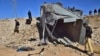 FILE - Pakistani security officials inspect a damaged truck at the site of suicide bombing on the outskirts of Quetta, Pakistan, Nov. 30, 2022. The outlawed Tehrik-e-Taliban Pakistan, also known as the Pakistani Taliban, claimed responsibility for the attack.