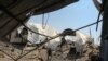A man inspects the damage at a site targeted by an Israeli air strike a day before in Khan Younis in the southern Gaza strip on May 30, 2018.