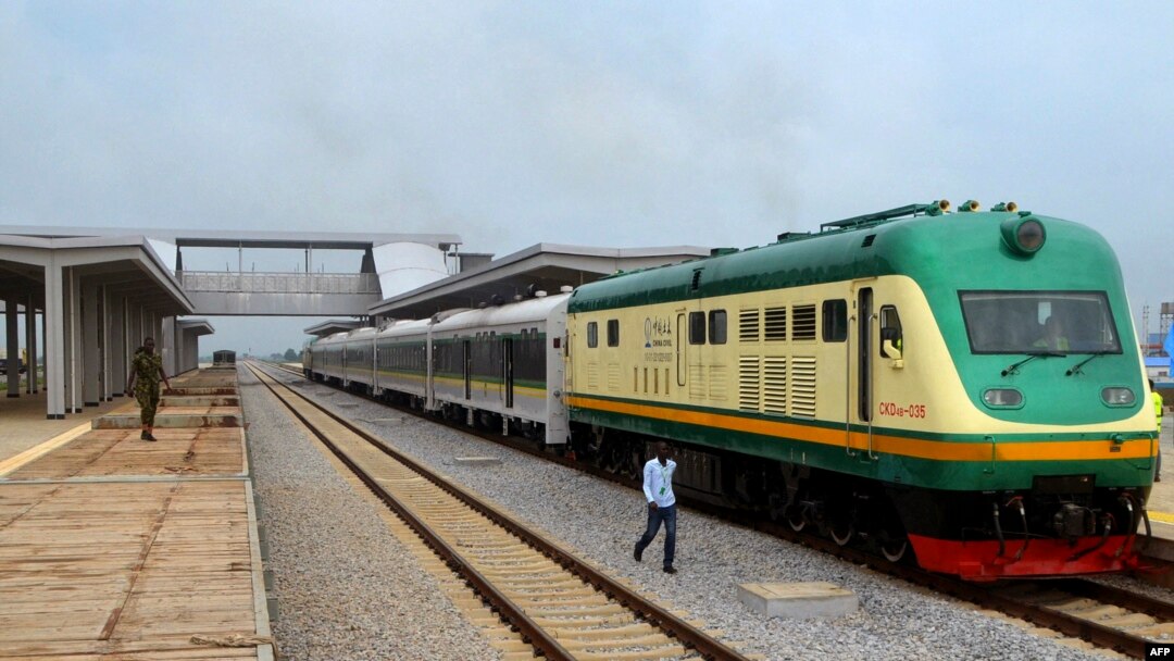 FILE - A man walks past a train of the newly completed Abuja-Kaduna railway line in Abuja, July 21, 2016. 