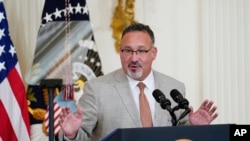 FILE - Education Secretary Miguel Cardona speaks during a White House event, April 27, 2022. As of Wednesday, he said, the Biden-Harris administration will discharge the federal student loans of "every student deceived, defrauded and driven into debt by Corinthian Colleges."