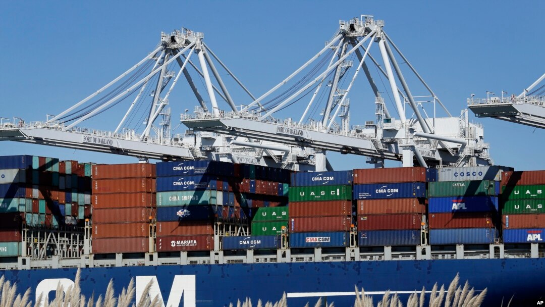 FILE - In this Oct. 26, 2016, photo, a container ship waits to be unloaded at the Port of Oakland, as seen from Alameda, Calif. 