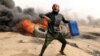 FILE - A Palestinian demonstrator is pictured during clashes with Israeli troops at a protest on the Israel-Gaza border where Palestinians are demanding the right to return to their homeland, April 20, 2018. 