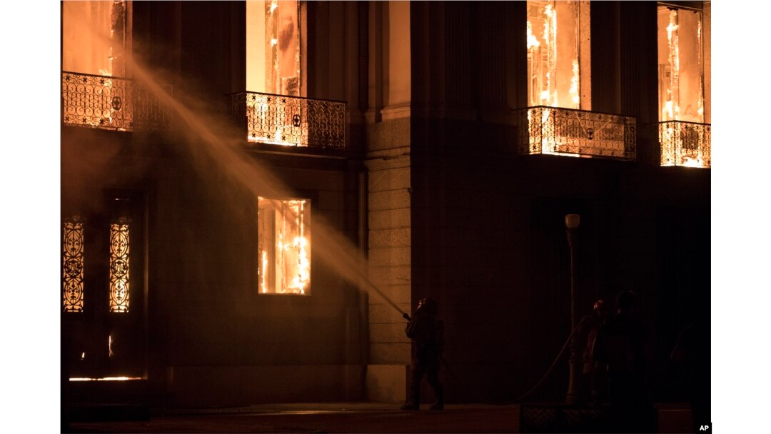 Firefighters spray the flames at the 200-year-old National Museum of Brazil, in Rio de Janeiro, Brazil, Sept. 2, 2018.