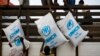 FILE - Workers unload sacks of UNHCR aid supplies at the Al Adala settlement for internally displaced people in Mogadishu, Somalia, Aug.13, 20.