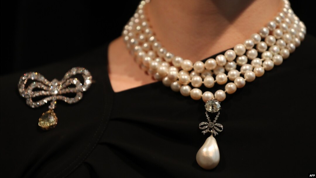 In this file photo taken on Oct. 19, 2018, a model wears the 'Queen-Marie Antoinette's Pearl.' and a diamond brooch belonging to Queen Marie-Antoinette.