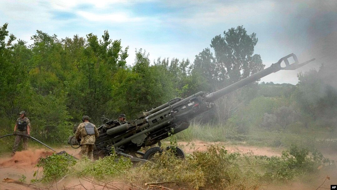 FILE - Ukrainian soldiers fire at Russian positions from a U.S.-supplied M777 howitzer in Ukraine's eastern Donetsk region, June 18, 2022. 