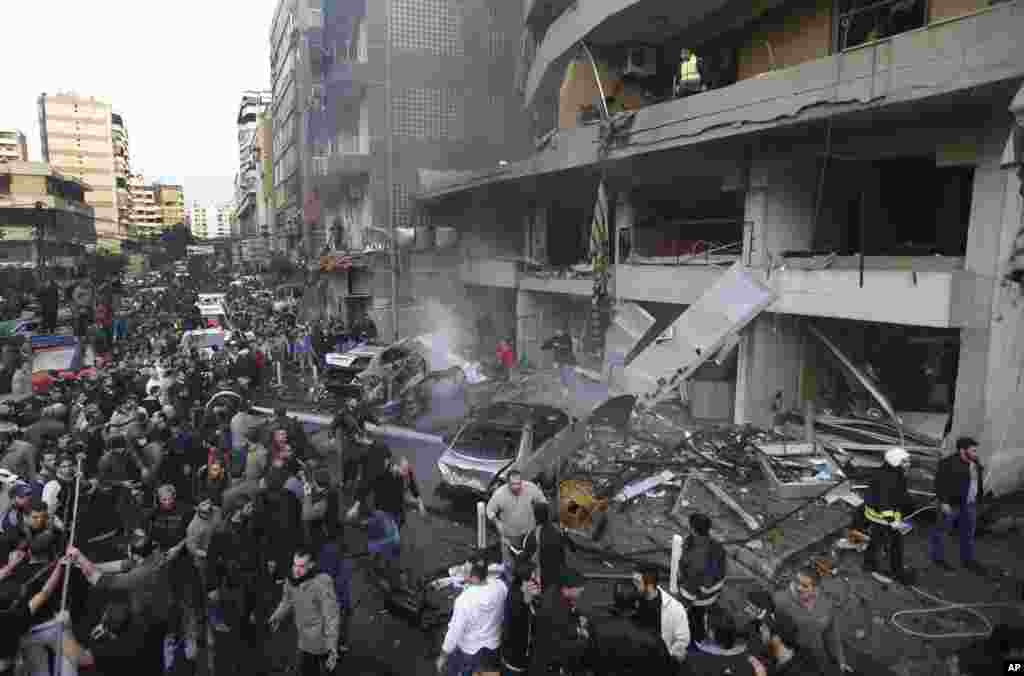 Lebanese citizens gather at the site of a car bomb explosion in a southern suburb of Beirut, Jan. 2, 2014.