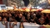 Protesters carrying umbrellas in colors of the national flag march through a street in Skopje, Macedonia, March 10, 2017. Thousands of Macedonians have been protesting against the designation of Albanian as a second official language nationwide.