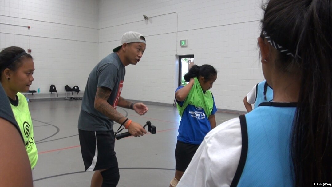 Kyle Johnson, who co-founded Like a Girl, works on strategy with his players.