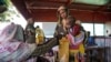 FILE - A handout photograph, shot in January 2024, shows a woman and baby at the Zamzam displacement camp, close to El Fasher in North Darfur, Sudan.
