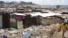 FILE - A man walks by the slum of Mathare in Nairobi, May 28, 2014. 