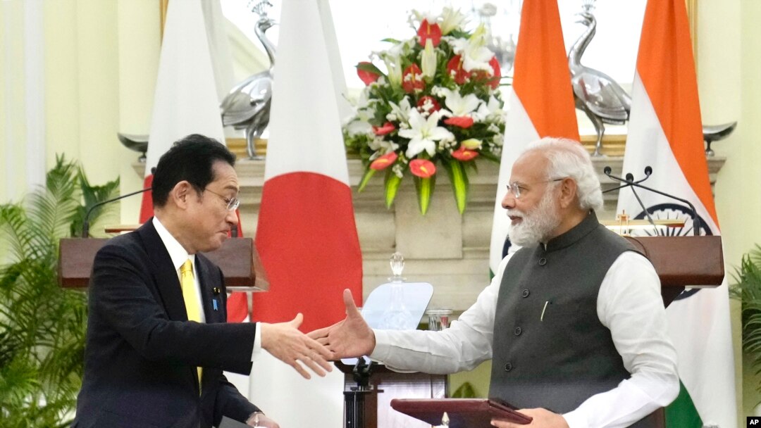 Indian Prime Minister Narendra Modi shakes hand with his Japanese counterpart Fumio Kishida during a signing of agreements in New Delhi, March 19, 2022. Kishida said his country will invest $42 billion in India over the next five years in a deal to boost