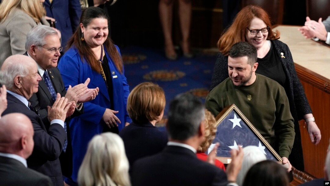 Ukrainian President Volodymyr Zelenskyy holds an American flag that was gifted to him by House Speaker Nancy Pelosi of Calif., as he leaves after addressing a joint meeting of Congress on Capitol Hill in Washington, Dec. 21, 2022. 