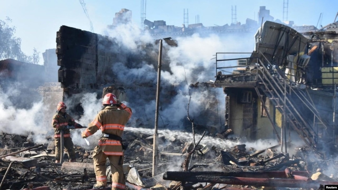 Firefighters work in a residential area damaged by a Russian missile strike in the settlement of Zatoka, Odesa region, Ukraine July 26, 2022, in this photo provided by the State Emergency Service of Ukraine.