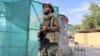A Taliban fighter stands guard near the site where al-Qaida leader Ayman al-Zawahiri was killed in a U.S. strike over the weekend, in Kabul, Afghanistan, Aug. 2, 2022. 