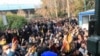 In this Saturday, Dec. 30, 2017 file photo taken by an individual not employed by the Associated Press and obtained by the AP outside Iran, university students attend a protest inside Tehran University while anti-riot Iranian police prevent them to join o