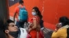 A man reacts as a healthcare worker collects a swab sample, amidst the spread of the coronavirus disease (COVID-19), at a railway station, in New Delhi, India, Apr. 7, 2021.