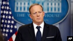 FILE - Then-White House press secretary Sean Spicer listens to a reporter's question during a briefing at the White House, June 20, 2017.