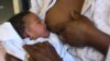 FILE - A mother is seen breastfeeding her child.