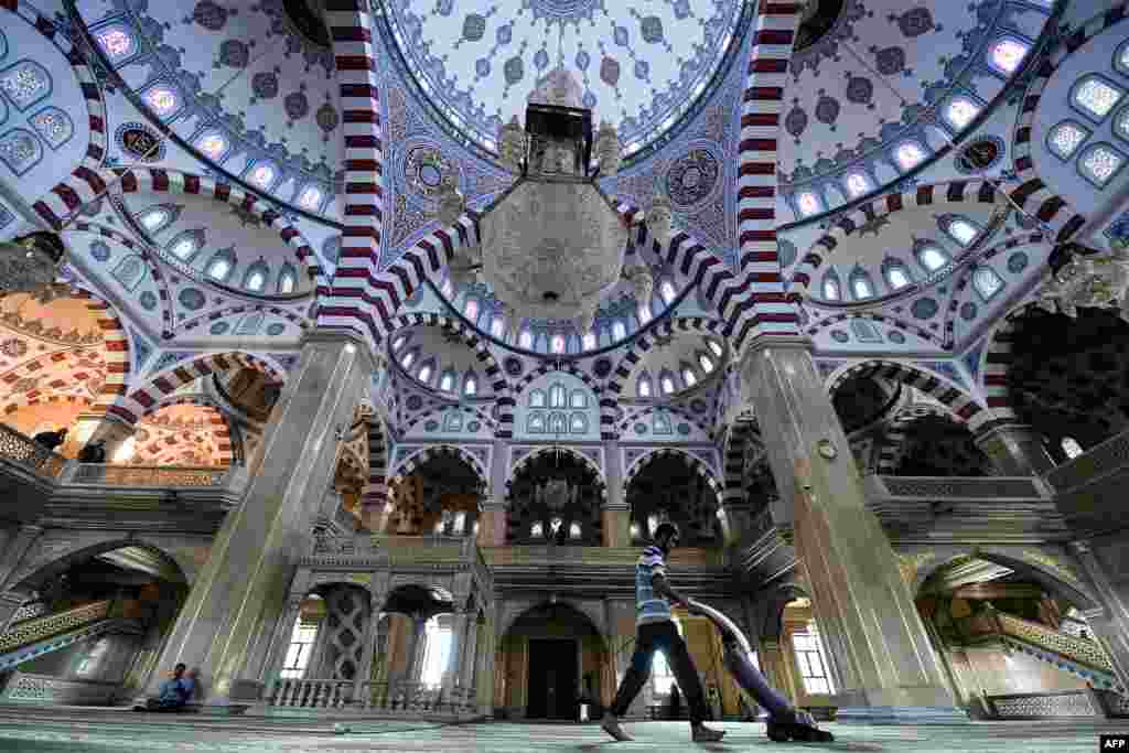 A man cleans inside the Heart of Chechnya - Akhmad Kadyrov Mosque in central Grozny.
