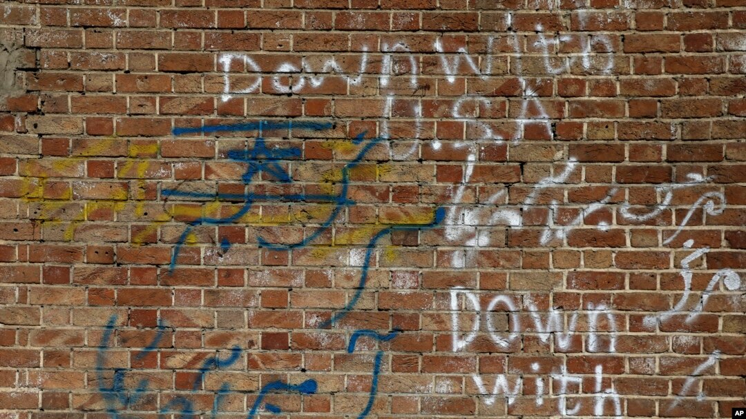 FILE - Anti-U.S. and Israeli slogans are written on the wall of the former U.S. Embassy in Tehran, Iran, Oct. 15, 2019.